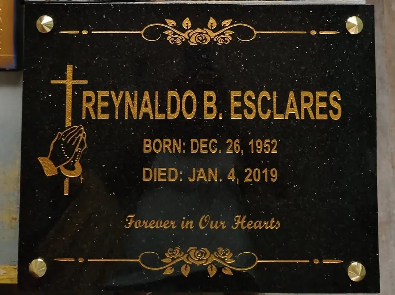 Black galaxy granite lapida with gold lettering, rose border and brass standoff fittings