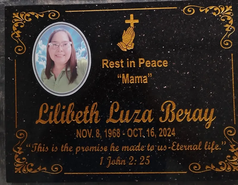 Black galaxy granite lapida with gold script lettering, gold scroll border and a ceramic portrait