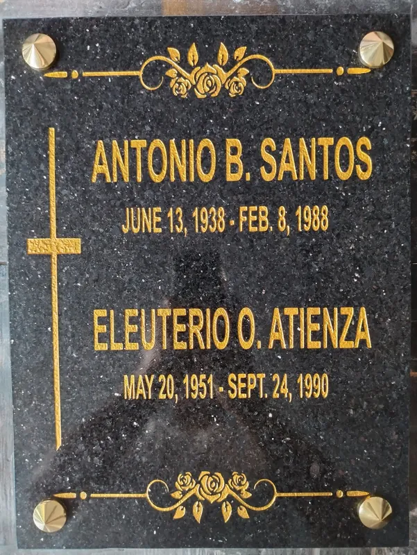 Vertical black galaxy granite lapida with gold lettering for two names, an engraved cross and rose borders